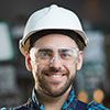 A man wearing safety glasses and a hard hat.