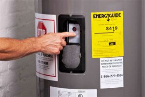 A person points to the water heater on display.